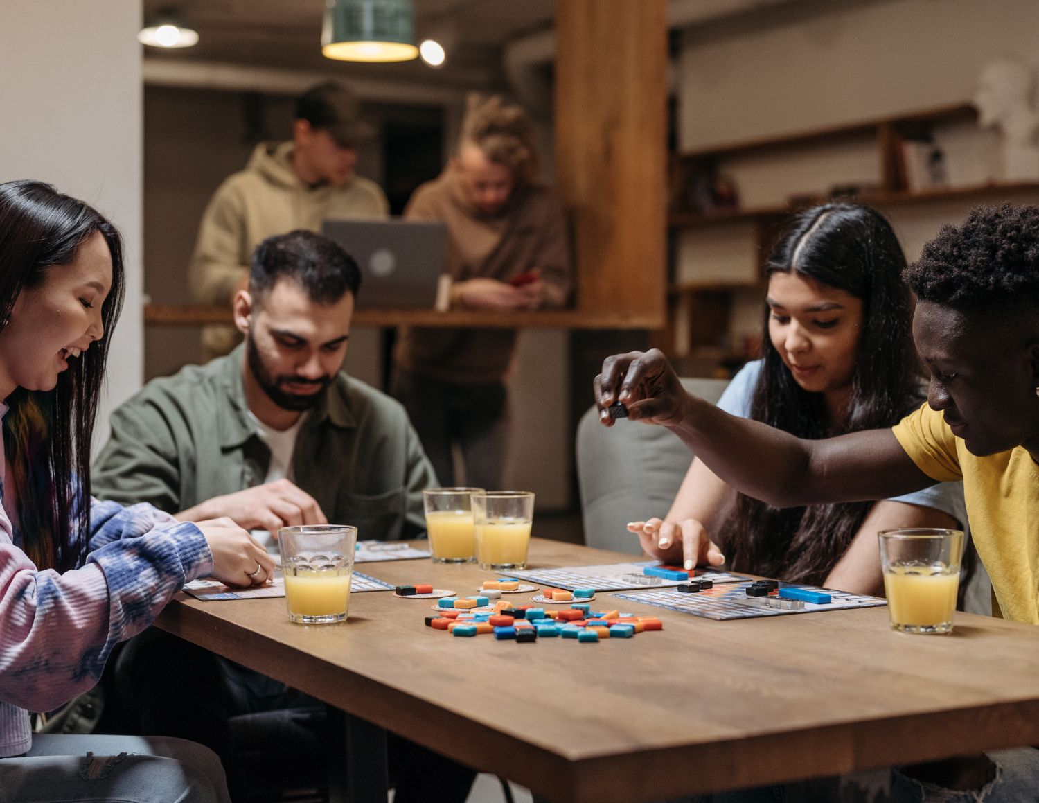 Group of people gathered around a board game,